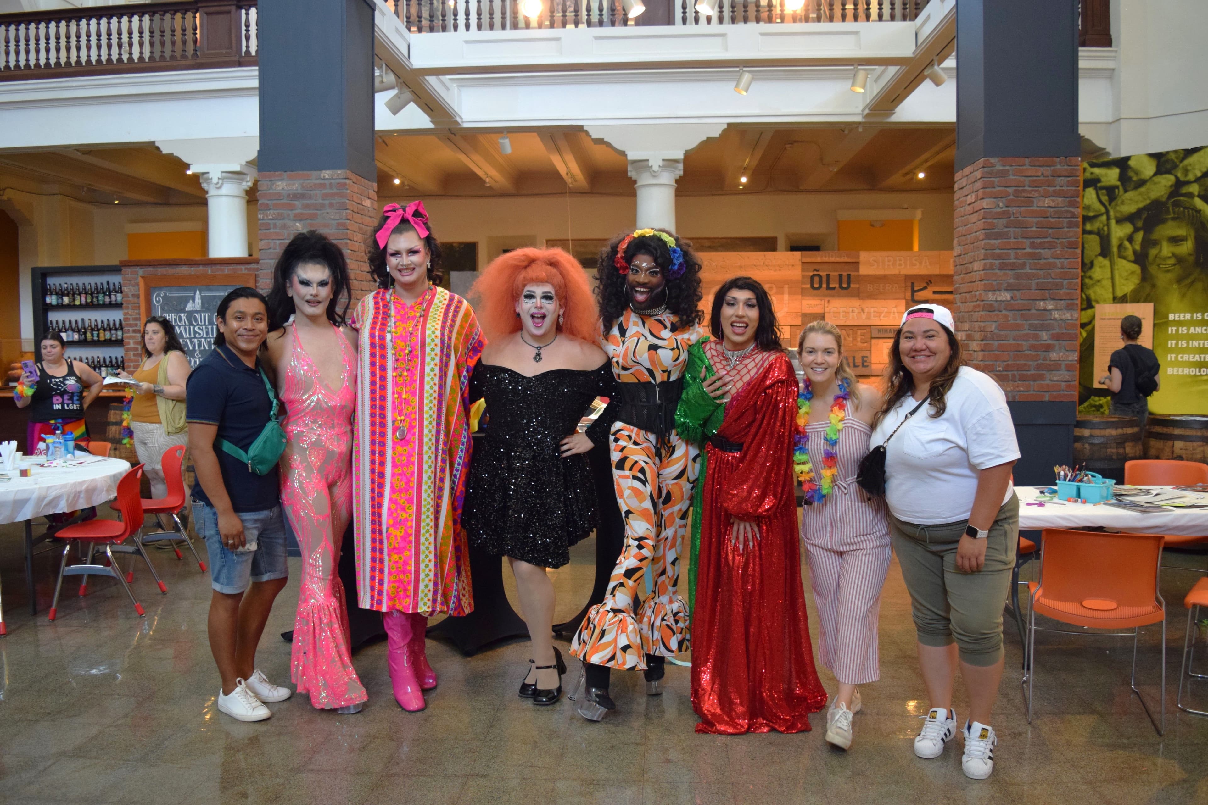 Photo of visitors posing with Queens from the Haus of St. James