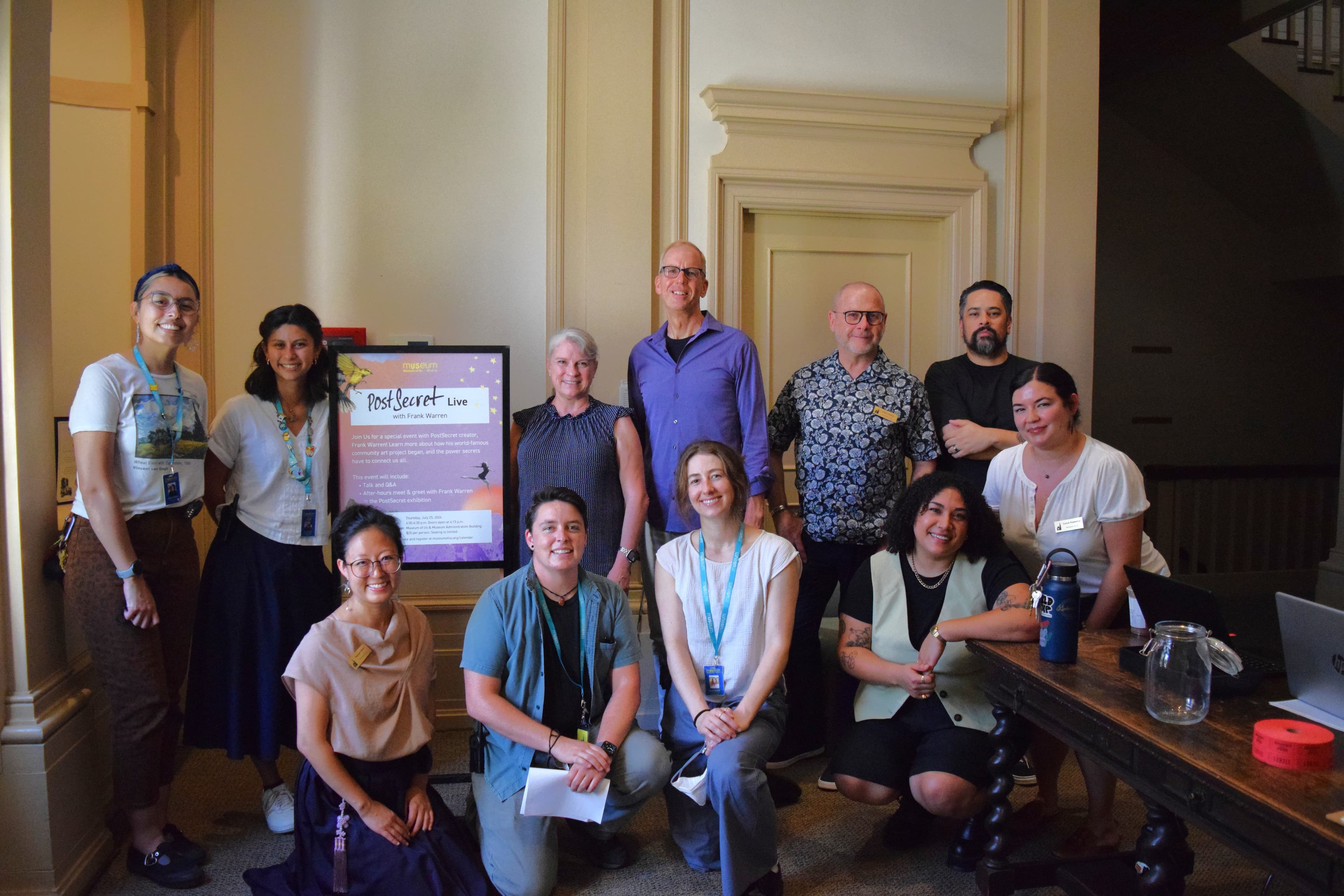 A group photo of Museum staff with Frank Warren