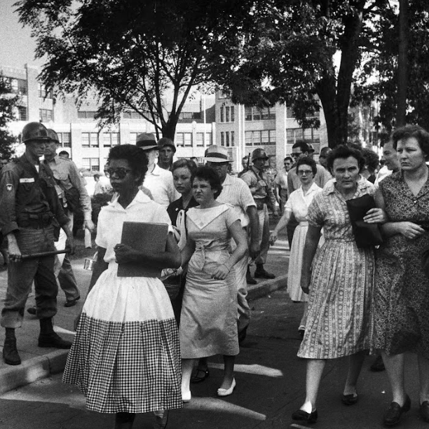 Vintage photograph of teenager Elizabeth Eckford with snarling white parents following as she is turned away from entering Central High School by Arkansas National Guardsmen.