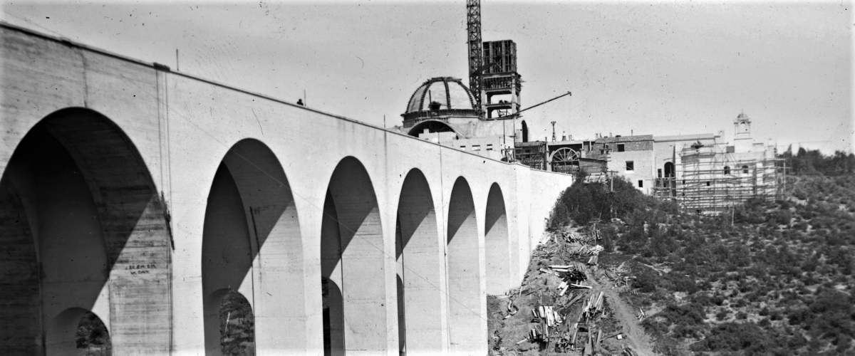 A vintage, black-and-white photograph of the Cabrillo Bridge and construction of the Museum of Us.