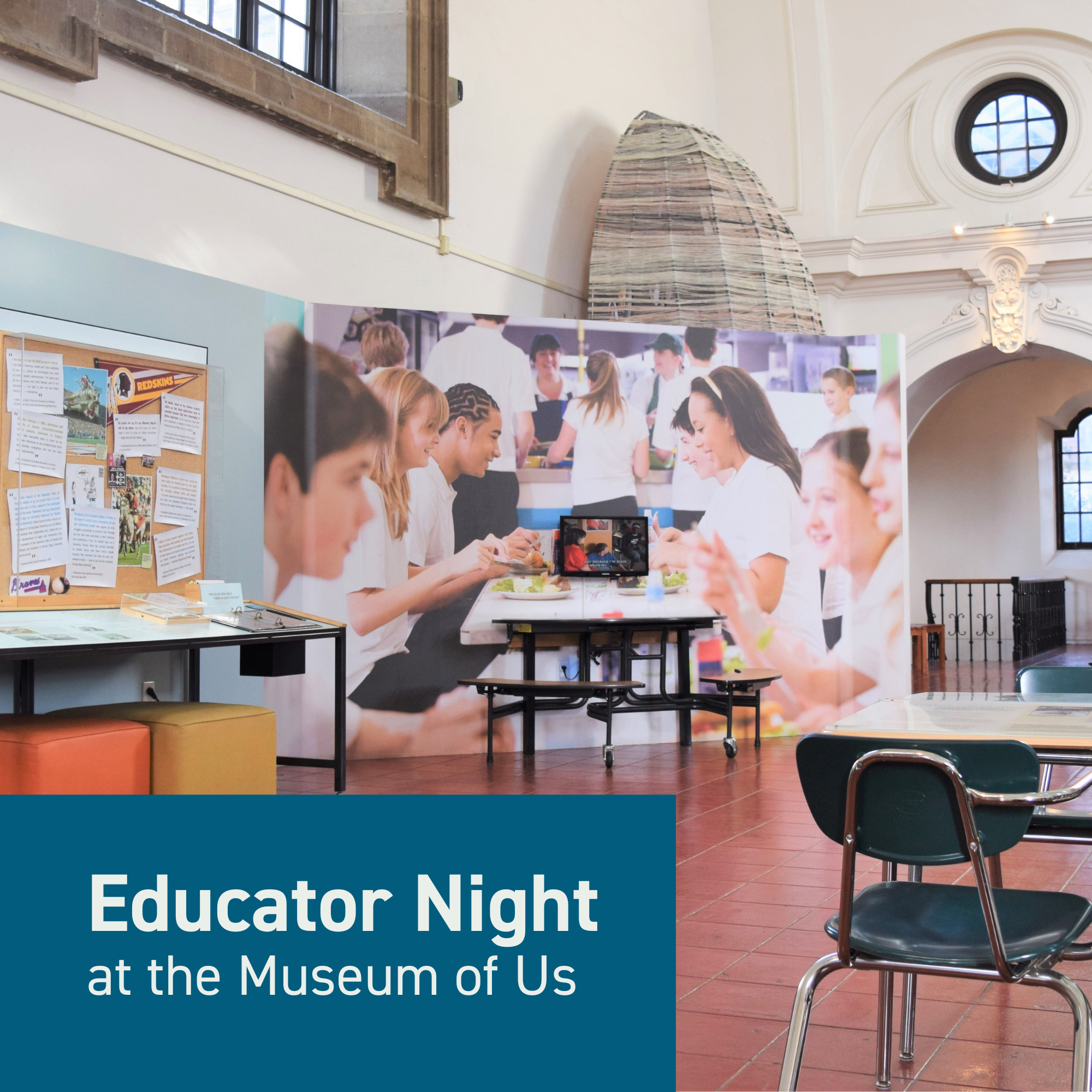 This image features a photo of the Race: Are We So Different? exhibition, with a small graphically design blue rectangle in the bottom left corner with white text that says "Educator Night at the Museum of Us" In the photo, we see exhibits that cover topics like types of mascots, the education system, and identity. On the left, there's an exhibit about school and sports mascots with examples. The other exhibits in the picture include two classroom desks facing each other with content on the tabletop of the desks, a school lunch table with a monitor that plays videos of people discussing race and identity.