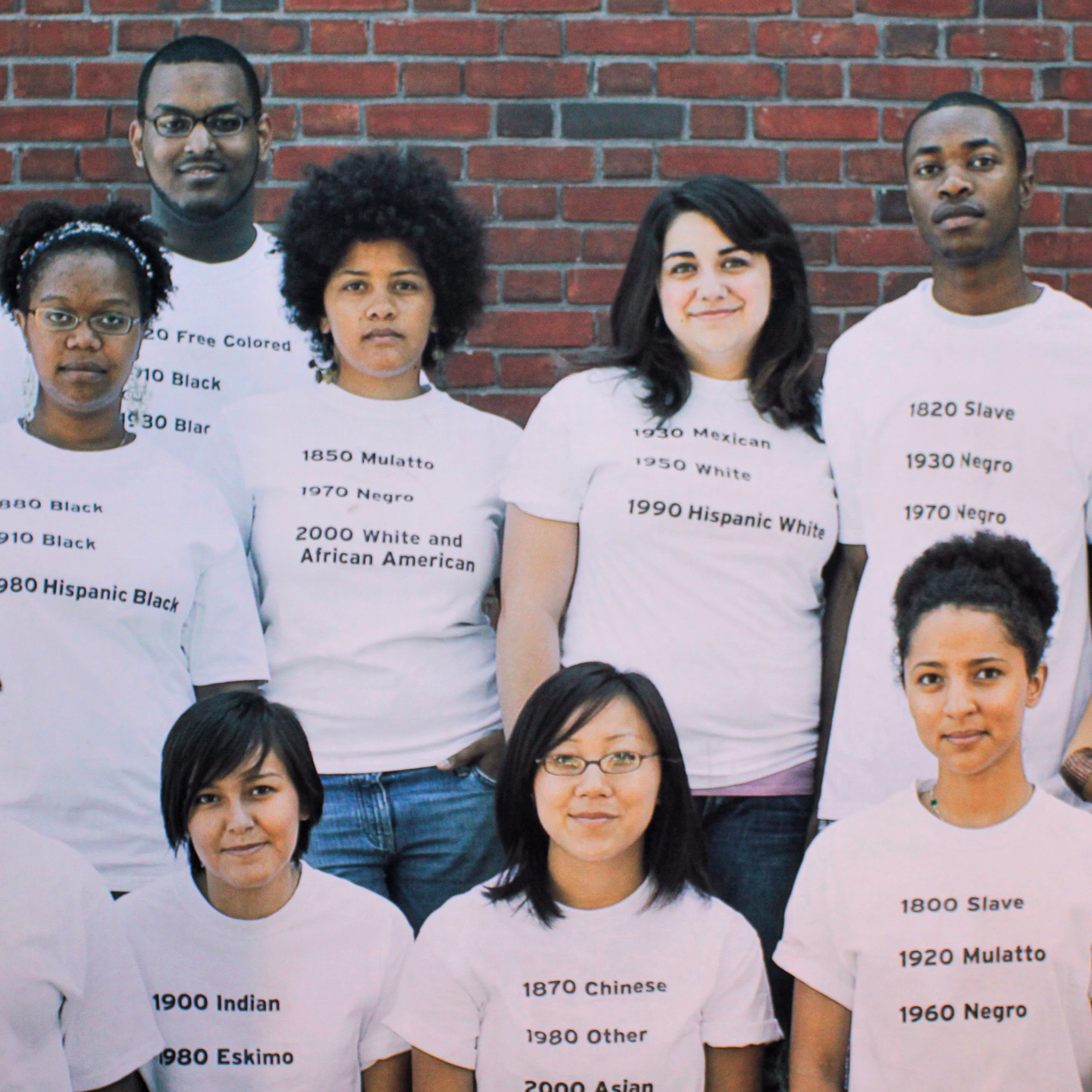 Group of young adults wearing t-shirts that document the evolution of how their race is referred to.
