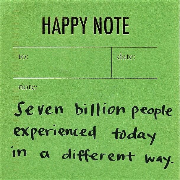 A note handwritten on a green piece of paper titled "Happy Note." The handwritten note reads, "Seven billion people experienced today in a different way."